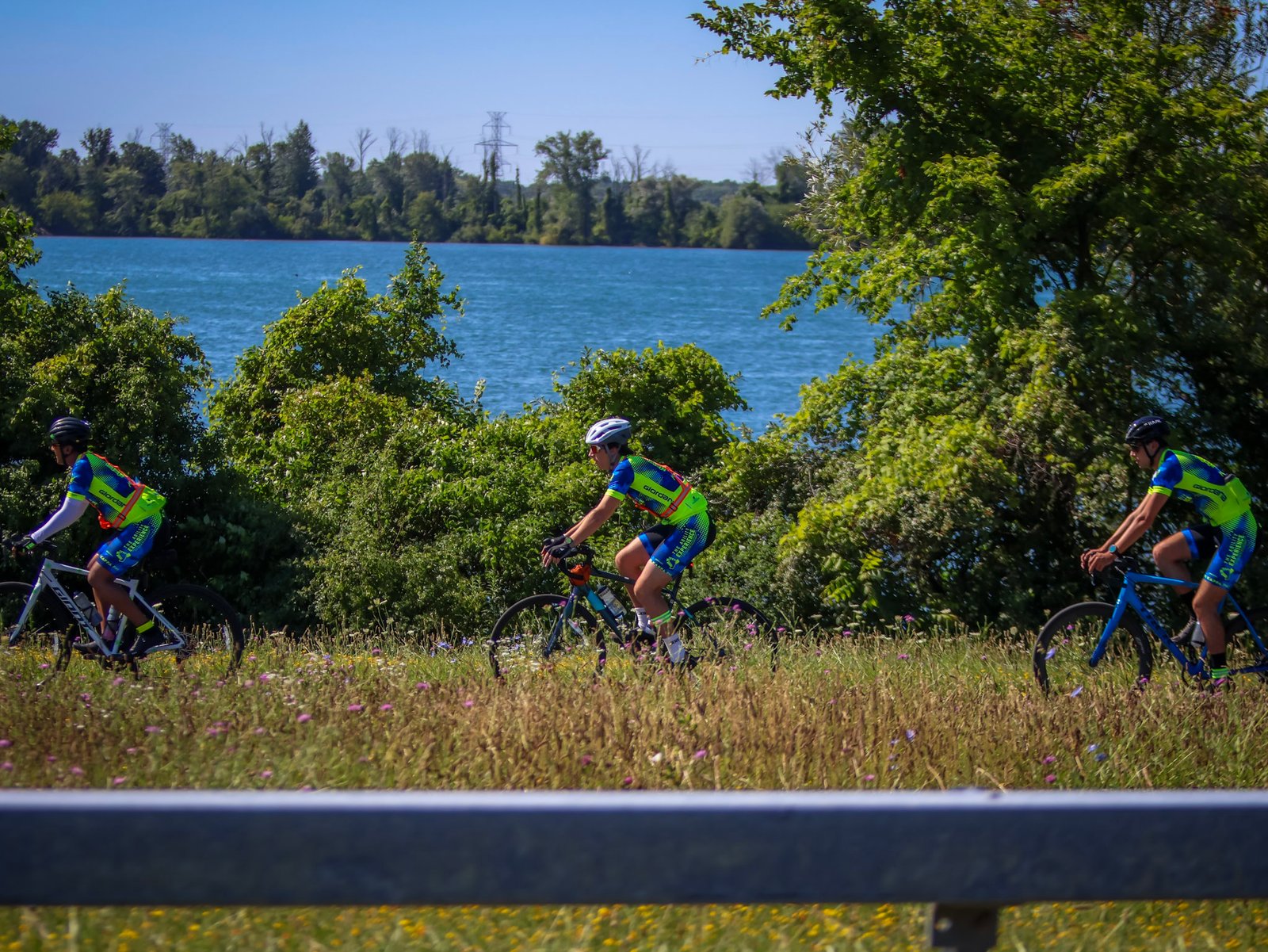 Gear Up New York cyclists riding beside a lake