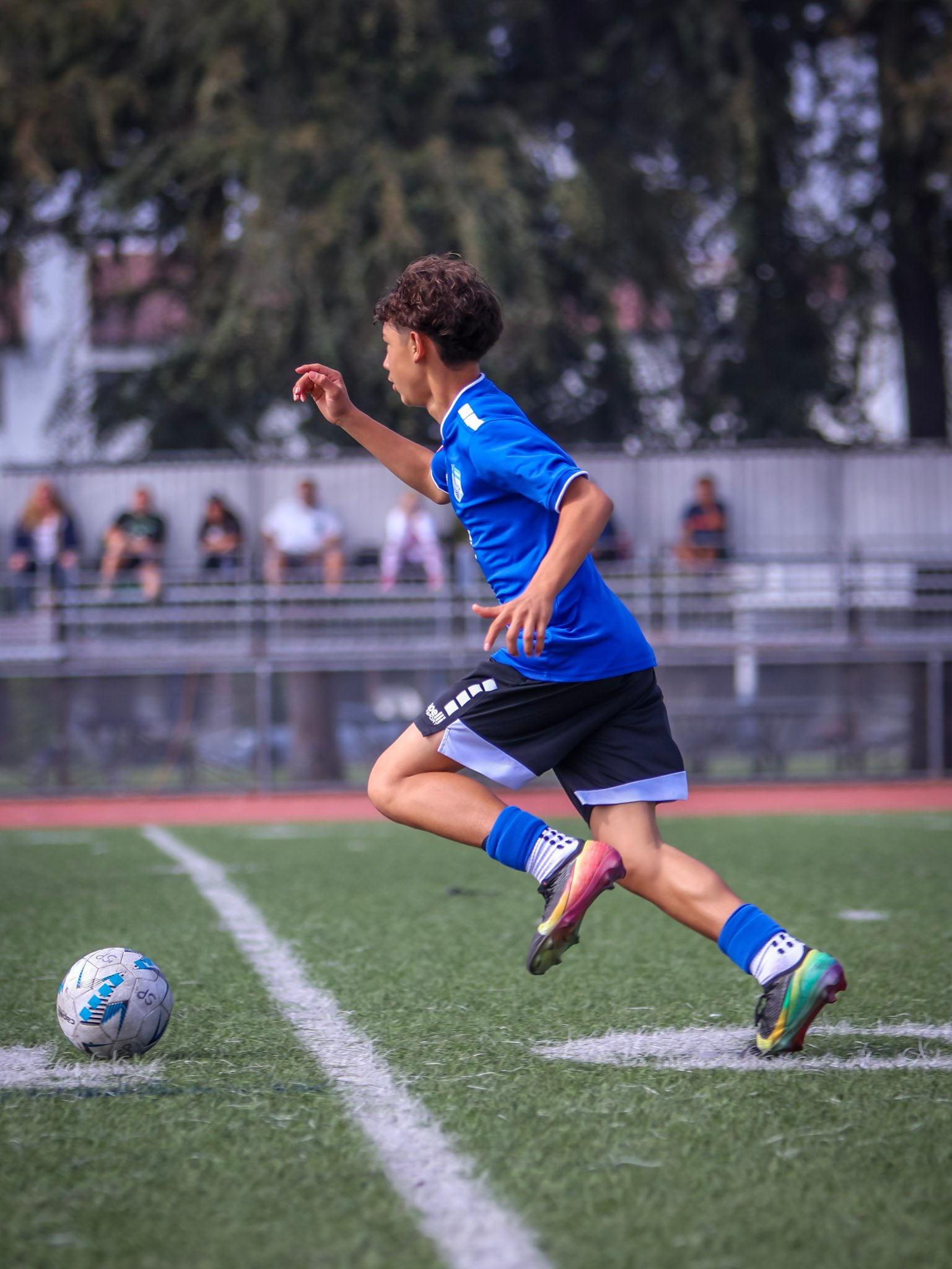 Soccer player driving the ball forward during a match