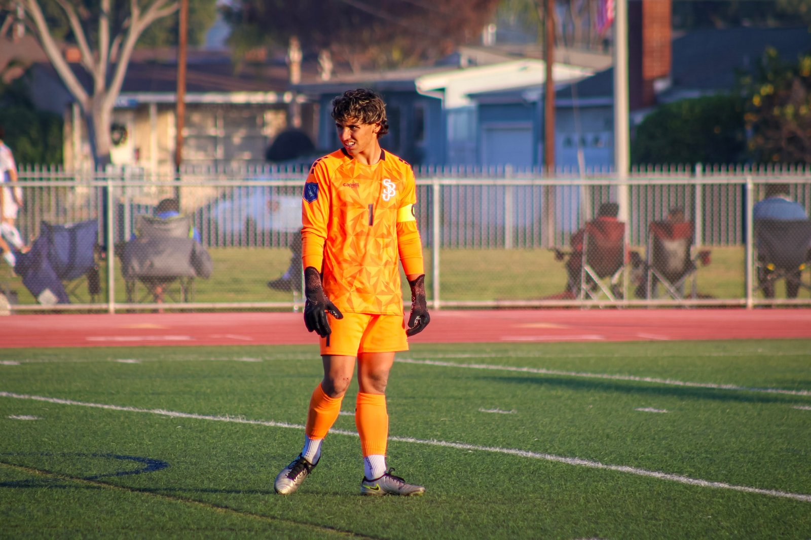 Goalkeeper in orange preparing for the next play