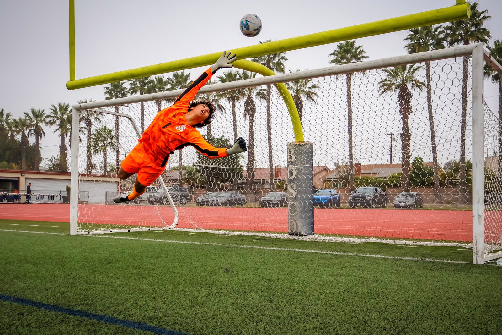 Goalkeeper diving to make a save during a soccer match