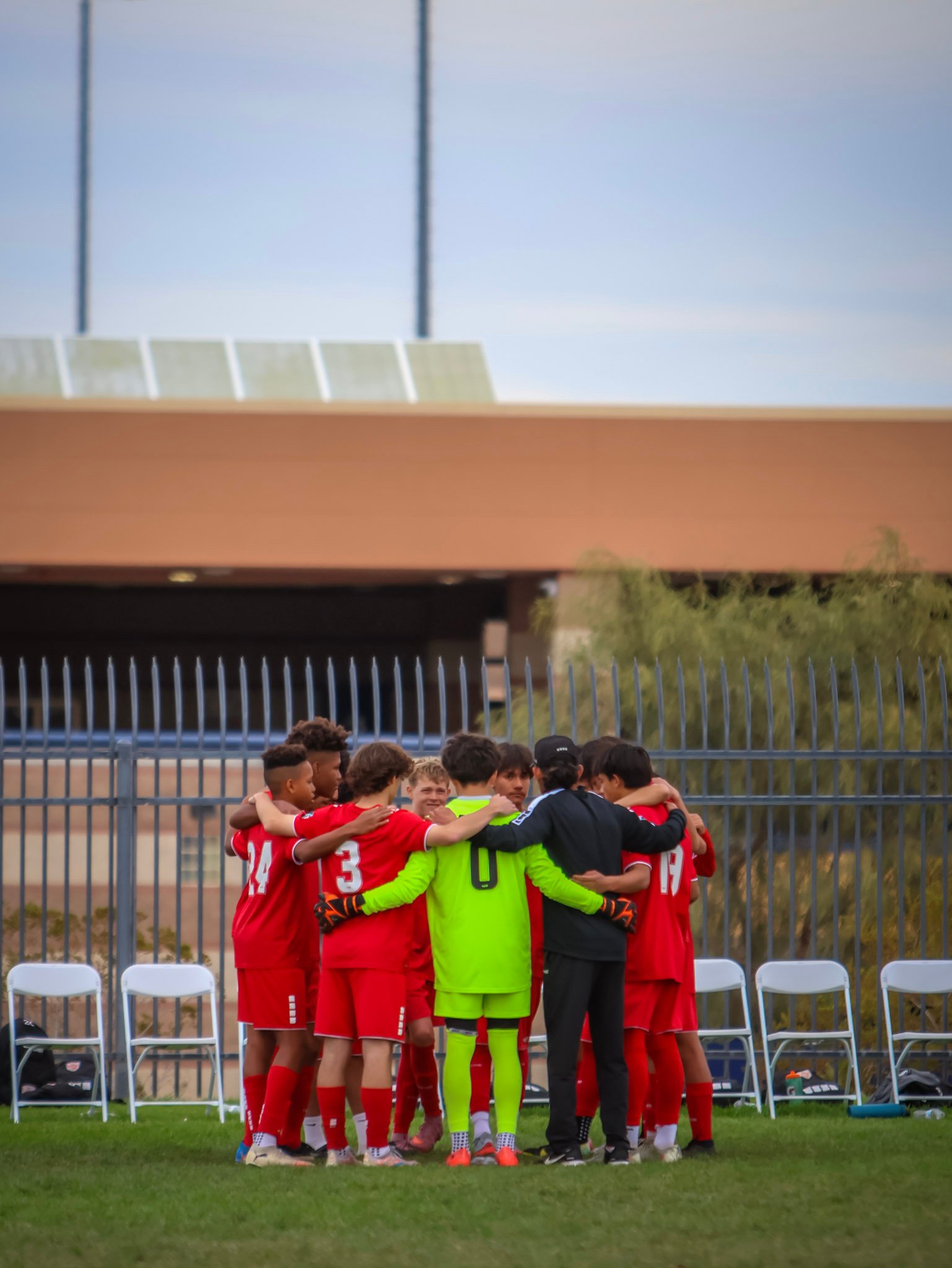 Soccer team gathered in a pregame huddle